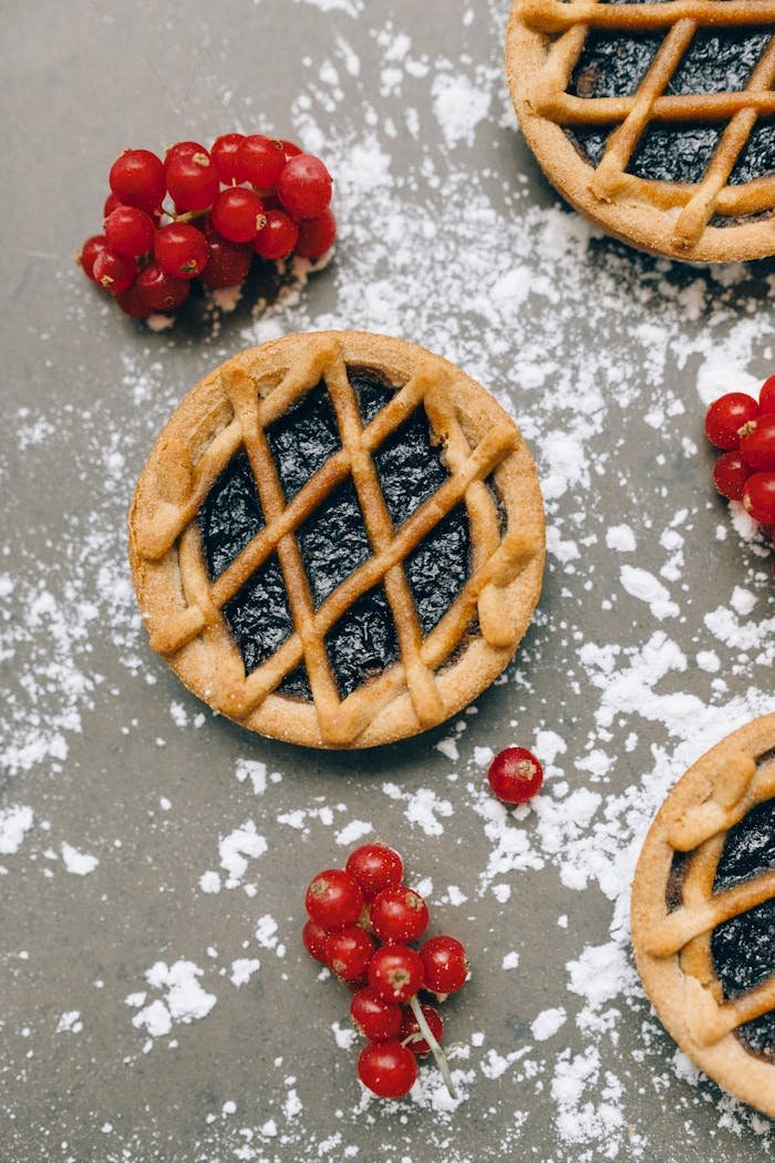 A delectable berry tart with lingonberries, captured in an artistic overhead shot.